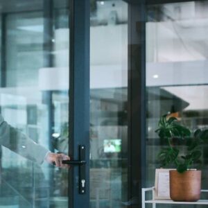 middle aged businesswoman smiling while exiting the building